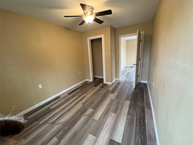 unfurnished room featuring ceiling fan, baseboards, and wood finished floors