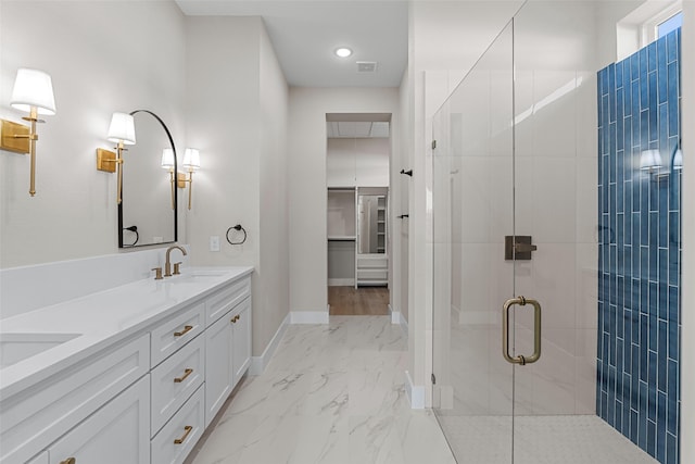 bathroom with marble finish floor, double vanity, a stall shower, a sink, and baseboards