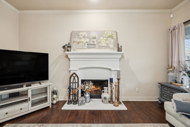 living area featuring ornamental molding, a lit fireplace, baseboards, and wood finished floors