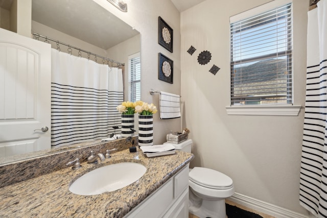 full bathroom featuring curtained shower, baseboards, vanity, and toilet