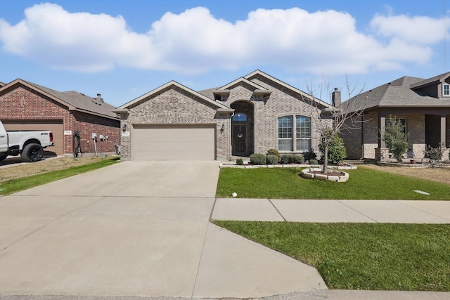 view of front of home featuring driveway, a garage, a front lawn, and brick siding