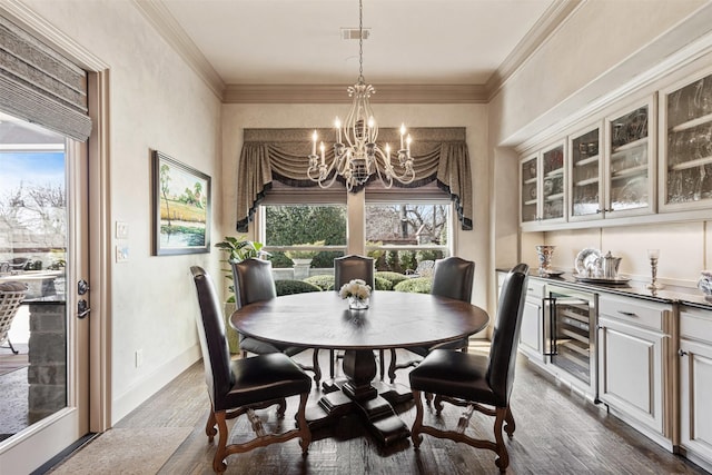 dining area with beverage cooler, ornamental molding, dark wood-type flooring, and baseboards