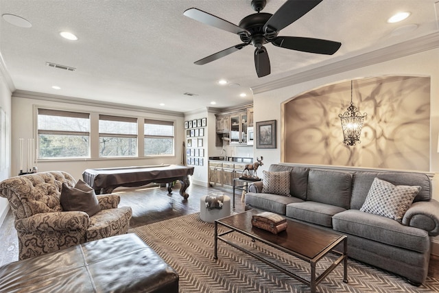 living area with billiards, visible vents, dark wood finished floors, crown molding, and a textured ceiling