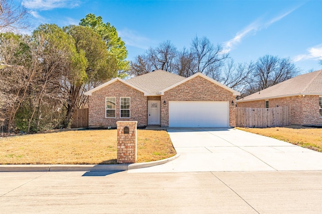 ranch-style home with a garage, concrete driveway, fence, a front lawn, and brick siding