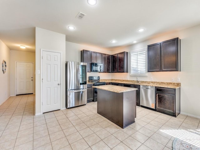 2404 Senepol Way, Fort Worth, TX 76131 - kitchen featuring black appliances, light stone countertops, a center island, light tile patterned flooring, and recessed lighting