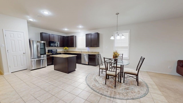 2404 Senepol Way, Fort Worth, TX 76131 - kitchen with black appliances, a center island, dark brown cabinetry, recessed lighting, and hanging light fixtures