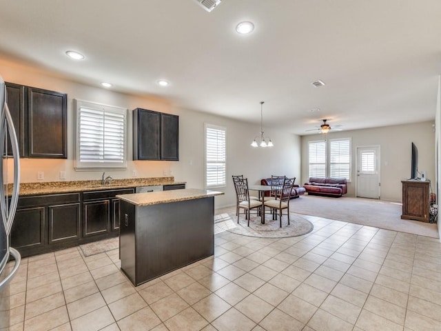 2404 Senepol Way, Fort Worth, TX 76131 - kitchen featuring plenty of natural light, recessed lighting, a kitchen island, open floor plan, and light stone counters
