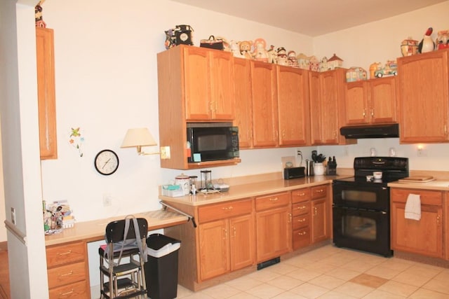 kitchen with under cabinet range hood, visible vents, light countertops, black appliances, and brown cabinetry