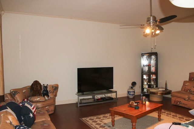 living room with wood finished floors, a ceiling fan, and baseboards