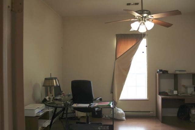 office area featuring a ceiling fan, visible vents, a baseboard heating unit, and light wood finished floors