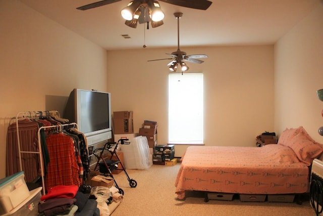 carpeted bedroom with visible vents and a ceiling fan