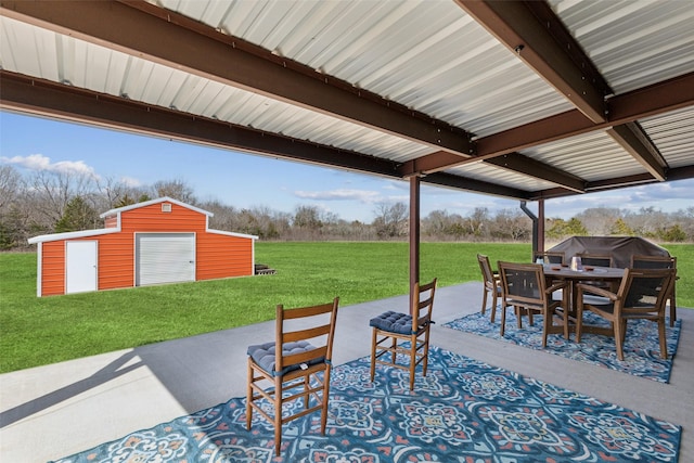 view of patio with an outbuilding and outdoor dining area