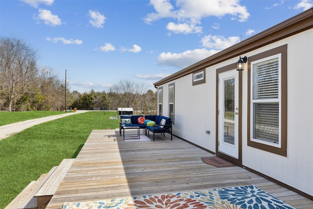 wooden deck featuring a yard and an outdoor living space