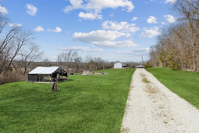 exterior space with an outbuilding and driveway