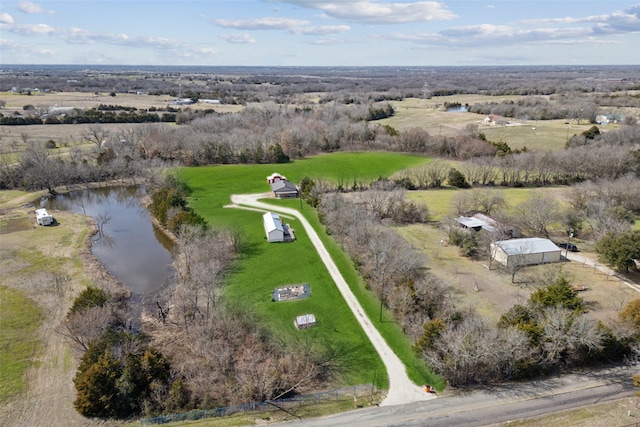 birds eye view of property featuring a water view and a rural view