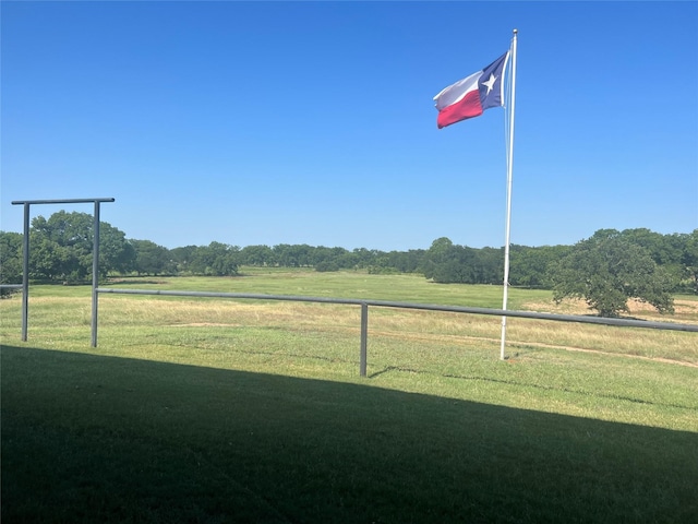 view of yard featuring a rural view and fence