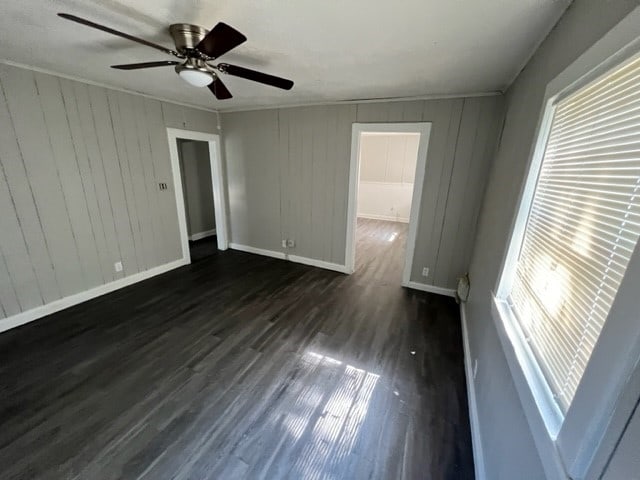 unfurnished room featuring dark wood finished floors and baseboards