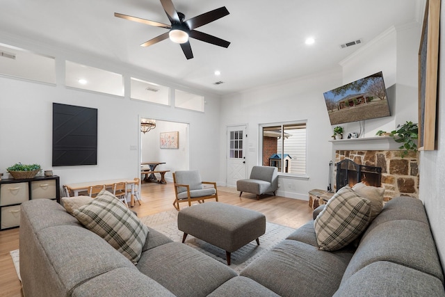 230 Holder Trl, Mckinney, TX 75071 - living room featuring light wood finished floors, crown molding, a chandelier, a ceiling fan, and recessed lighting