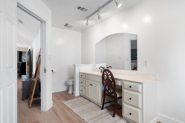 230 Holder Trl, Mckinney, TX 75071 - ensuite bathroom featuring vanity, wood finished floors, track lighting, toilet, and baseboards