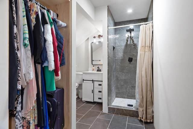 bathroom with tile patterned flooring, toilet, vanity, and a shower stall