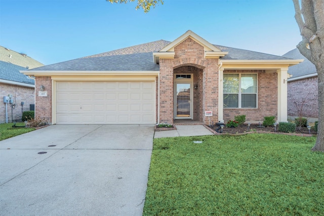 single story home featuring an attached garage, brick siding, concrete driveway, roof with shingles, and a front lawn