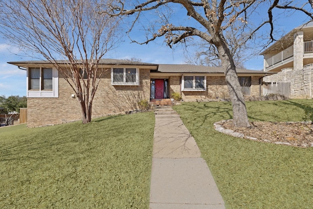 view of front of property featuring a front yard and brick siding