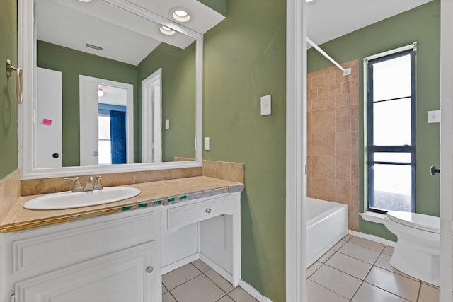 full bath with toilet, tile patterned flooring, a wealth of natural light, and vanity