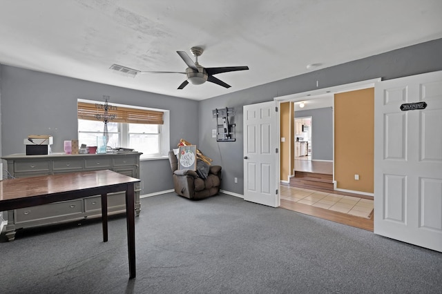 office space with ceiling fan, carpet floors, visible vents, and baseboards