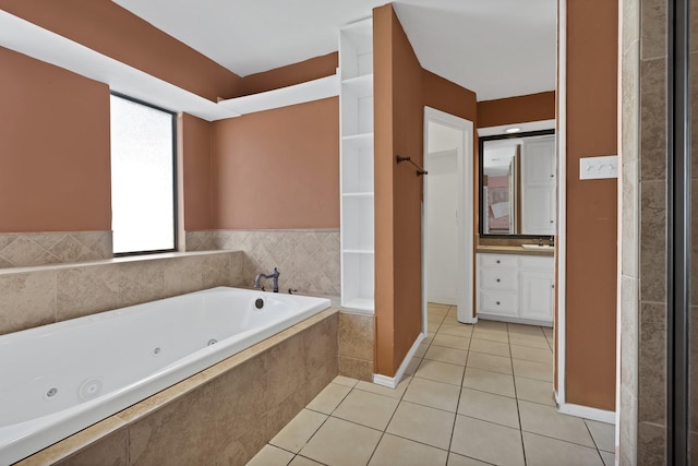 bathroom featuring a whirlpool tub, tile patterned flooring, and vanity