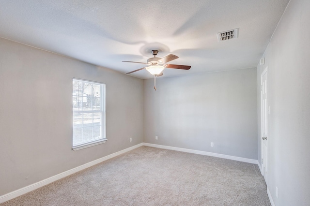 138 Whippoorwill Dr, Dallas, TX 75224 - empty room featuring ceiling fan, light colored carpet, baseboards, and a textured ceiling
