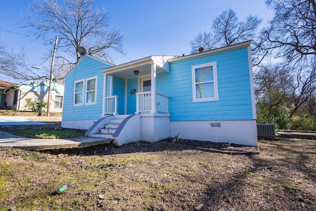 bungalow-style home featuring central AC unit and crawl space