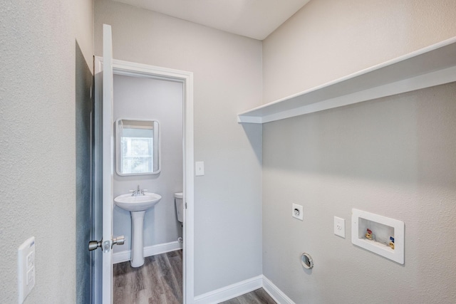 138 Whippoorwill Dr, Dallas, TX 75224 - laundry room with electric dryer hookup, wood finished floors, washer hookup, and baseboards