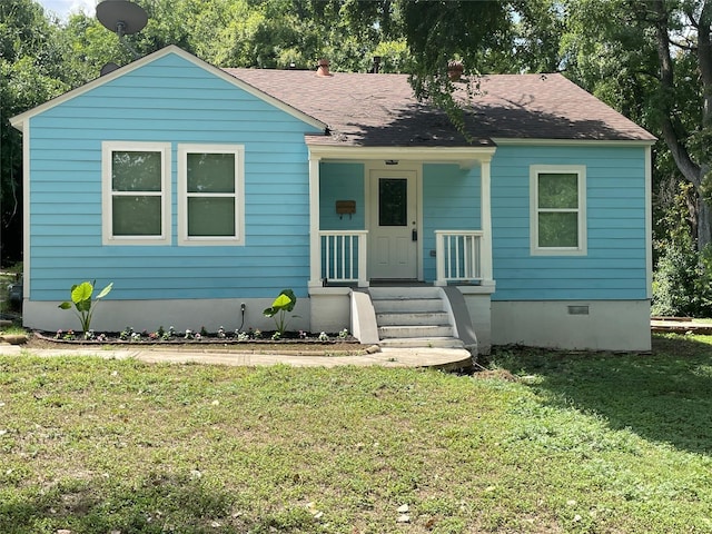 view of front of house featuring a front yard, crawl space, and roof with shingles