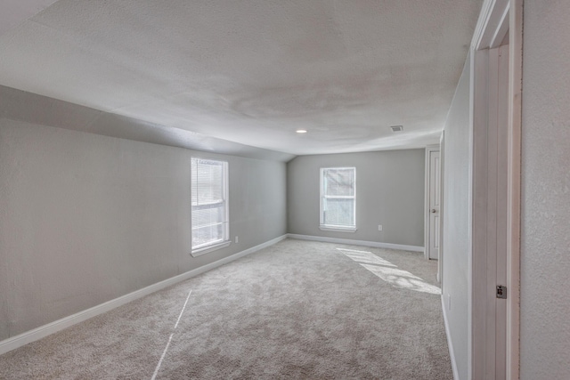 138 Whippoorwill Dr, Dallas, TX 75224 - carpeted empty room with baseboards, lofted ceiling, and a textured ceiling