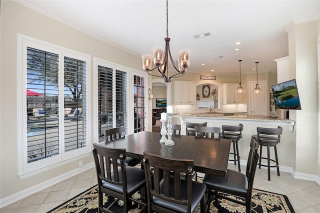 dining space with light tile patterned floors, visible vents, arched walkways, baseboards, and ornamental molding