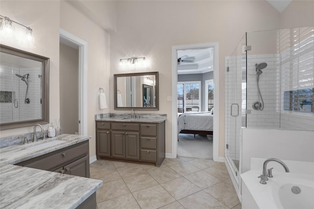 bathroom with a washtub, a stall shower, vanity, and tile patterned floors