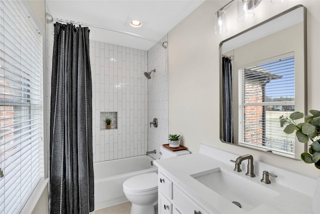 full bath with shower / tub combo, tile patterned flooring, vanity, and toilet