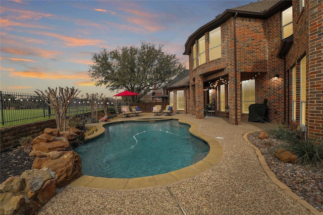 view of swimming pool featuring a patio, a fenced backyard, and a fenced in pool