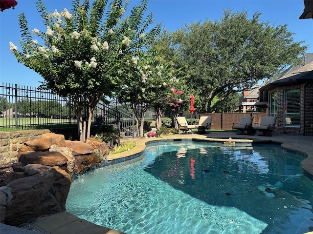 view of swimming pool featuring fence and a fenced in pool