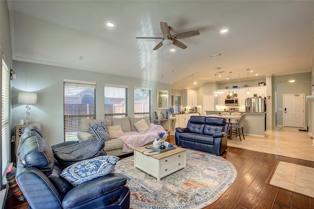 living room featuring crown molding, lofted ceiling, recessed lighting, visible vents, and hardwood / wood-style floors