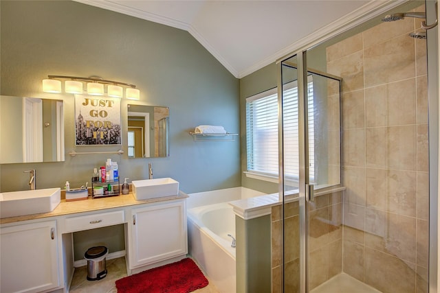 bathroom featuring ornamental molding, vaulted ceiling, a garden tub, and a sink