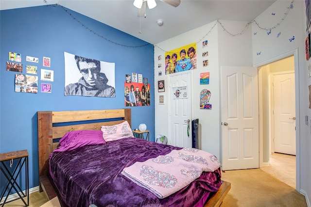 bedroom featuring lofted ceiling, carpet, ceiling fan, and tile patterned floors