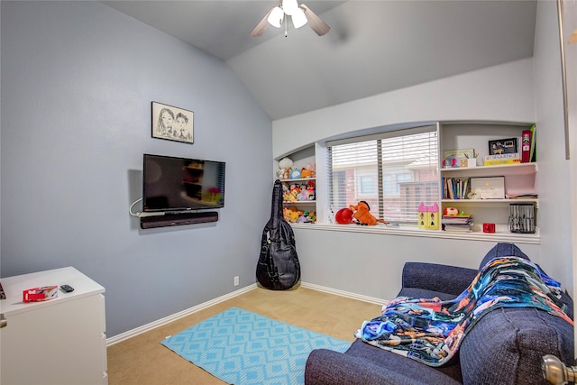 playroom featuring light colored carpet, vaulted ceiling, baseboards, and ceiling fan