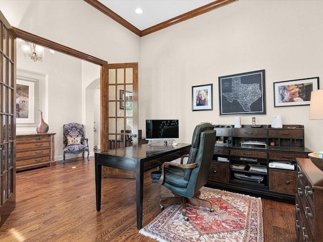 office space with arched walkways, a notable chandelier, crown molding, wood finished floors, and baseboards