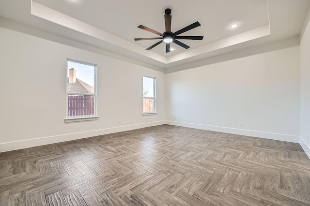 unfurnished room featuring baseboards, a tray ceiling, a ceiling fan, and recessed lighting