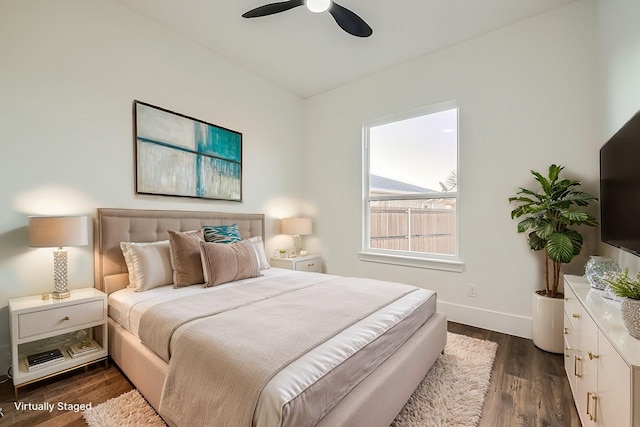 bedroom with ceiling fan, baseboards, and dark wood finished floors