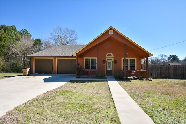 view of front of house with a porch, a front lawn, driveway, and an attached garage