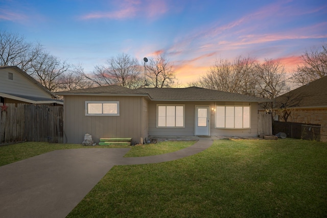 view of front facade with a front yard and fence