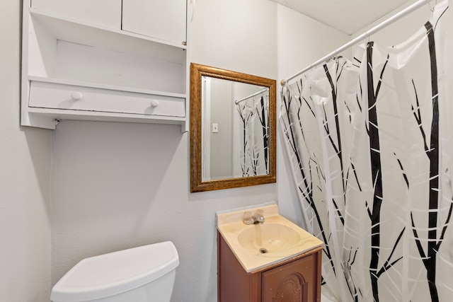 full bath featuring toilet, curtained shower, and vanity