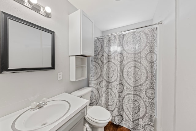 full bath with toilet, wood finished floors, a shower with shower curtain, and vanity